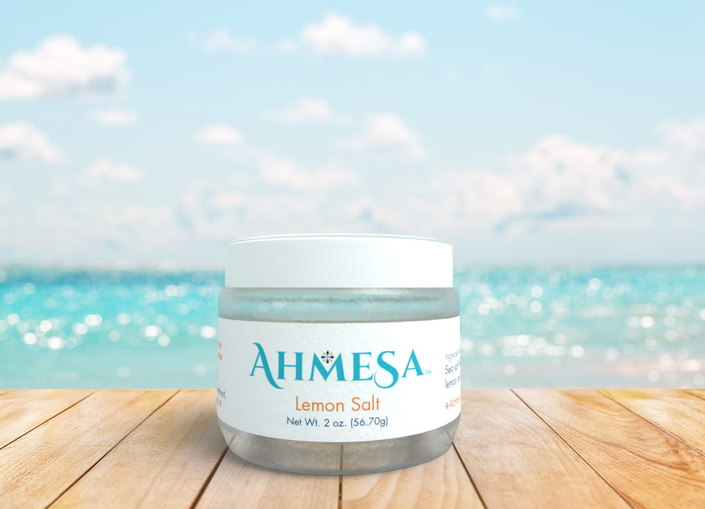 Ahmesa's Lemon Salt in its packaging, by seaside.